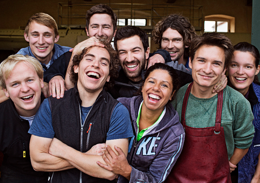 A group of young german winemakers smiling and laughing at the camera